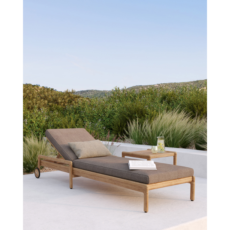 The Boucle Rectangular Outdoor Cushion from Ethnicraft in an outdoor living area.