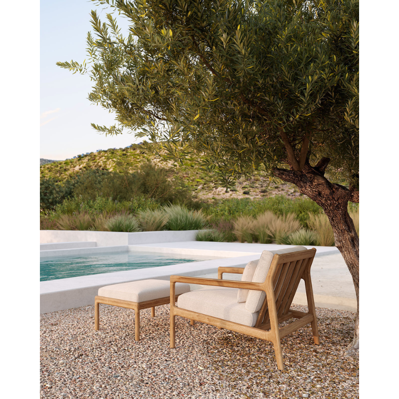 The Boucle Rectangular Outdoor Cushion from Ethnicraft in an outdoor spa area.