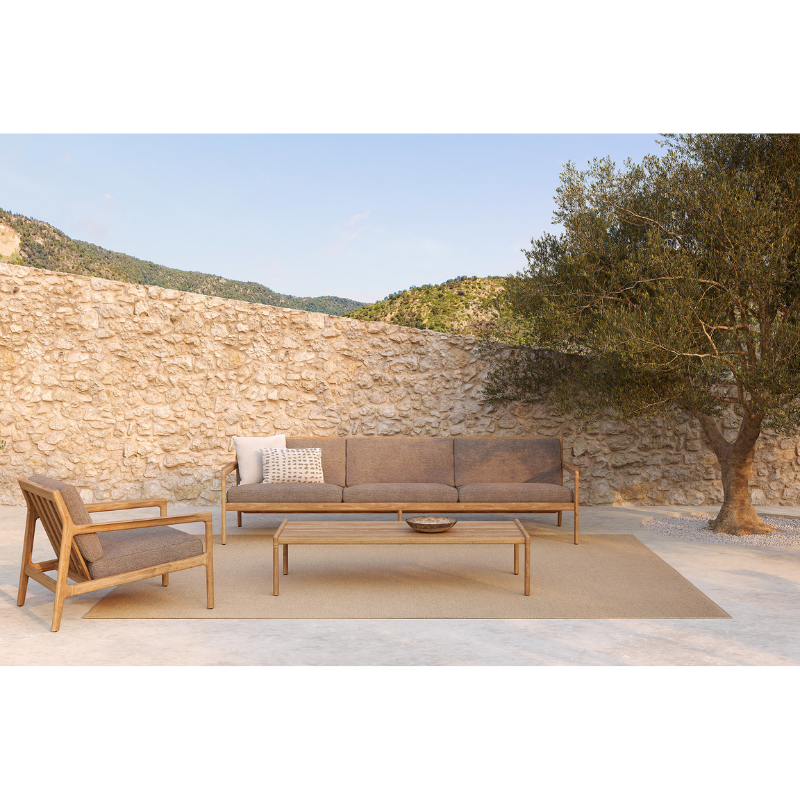 The Boucle Square Outdoor Cushion from Ethnicraft in a outdoor living area.