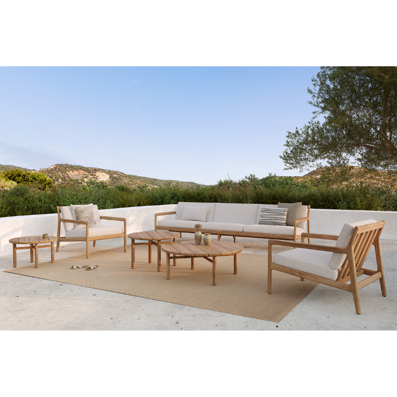 The Boucle Square Outdoor Cushion from Ethnicraft in an outdoor lounge.