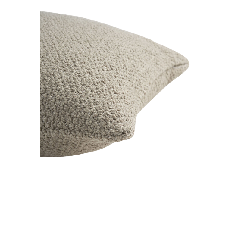 The Boucle Square Outdoor Cushion from Ethnicraft in oat in a detailed photograph.