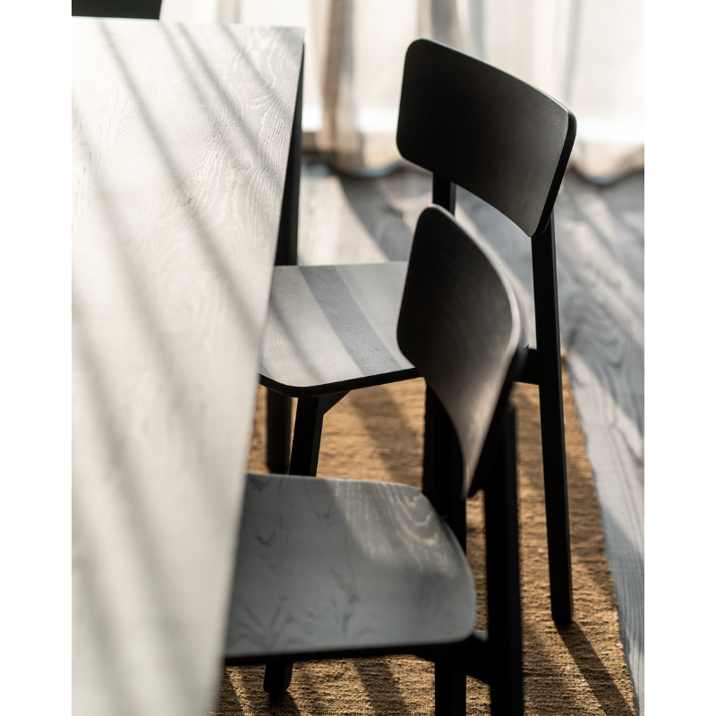 The Casale Dining Chair from Ethnicraft in a close up lifestyle photograph.