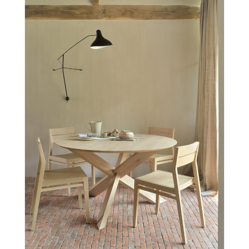 The Circle Dining Table from Ethnicraft in a dining room.