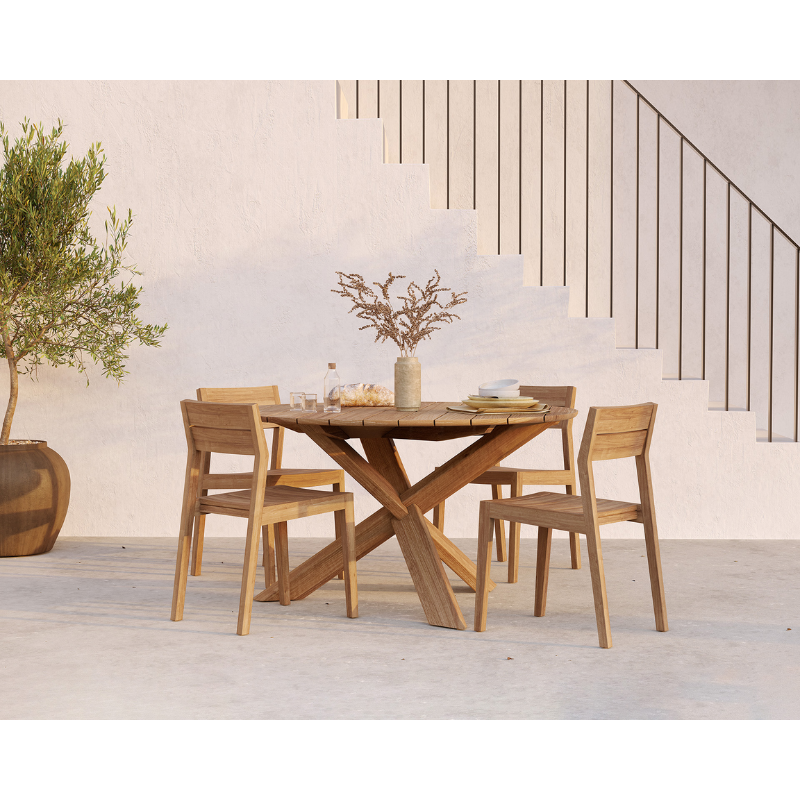 The Circle Outdoor Dining Table from Ethnicraft in an outdoor lounge area.