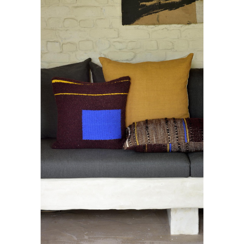 The Dark Tulum Cushion from Ethnicraft in a lounge lifestyle photograph.