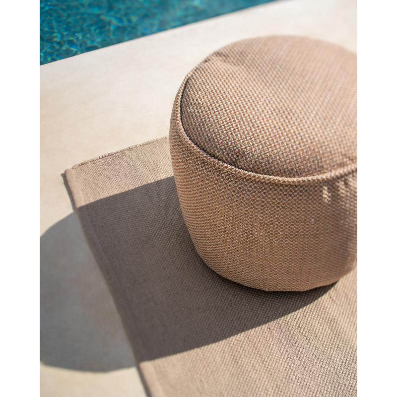 The Nomad Indoor and Outdoor Rug from Ethnicraft next to a pool.