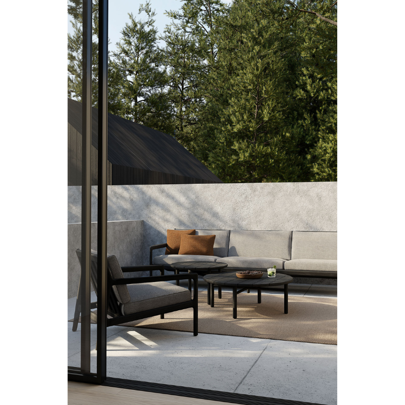 The Nomad Rectangular Outdoor Cushion by Ethnicraft in an outdoor living area.