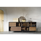 The Oscar sideboard in solid teak by Alain van Havre is the perfect multi-tasker: its open spaces can be used to exhibit personal objects, whereas the sliding doors offer the option of organizing documents out of sight. Notice the exceptional grooves in the doors: each narrow groove was carefully hand carved, making every Oscar piece unique.