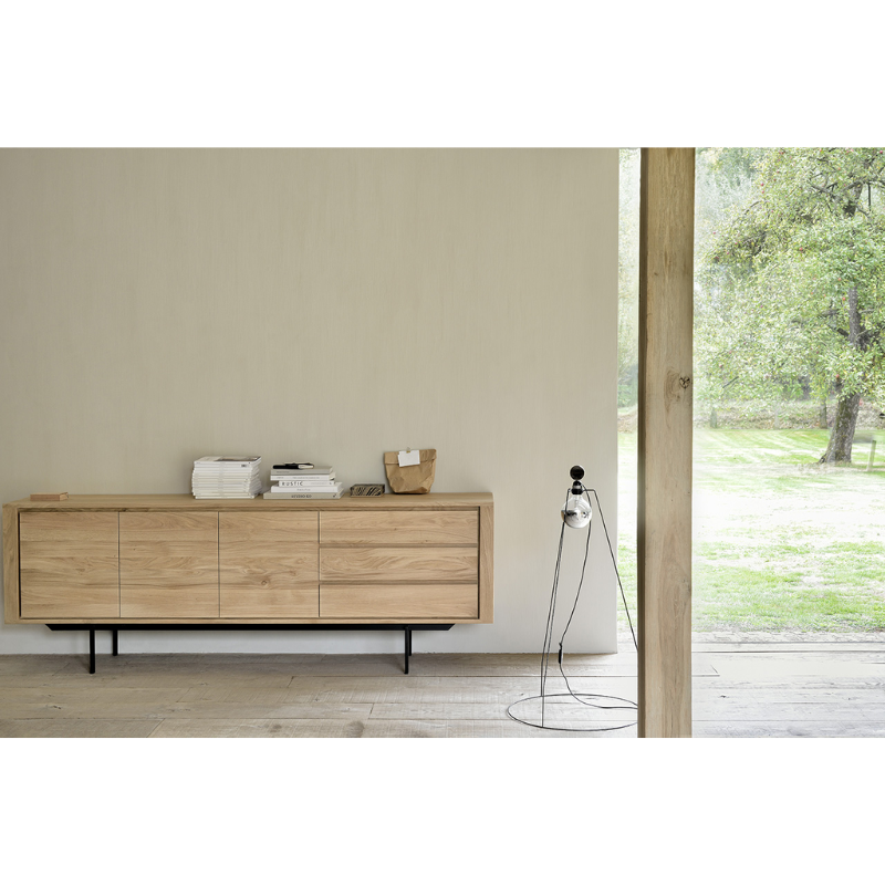 The Shadow sideboard is straightforward and robust with decisive lines. This more recent design with black metal legs, giving the design room to breathe, elevates this sideboard to new heights.