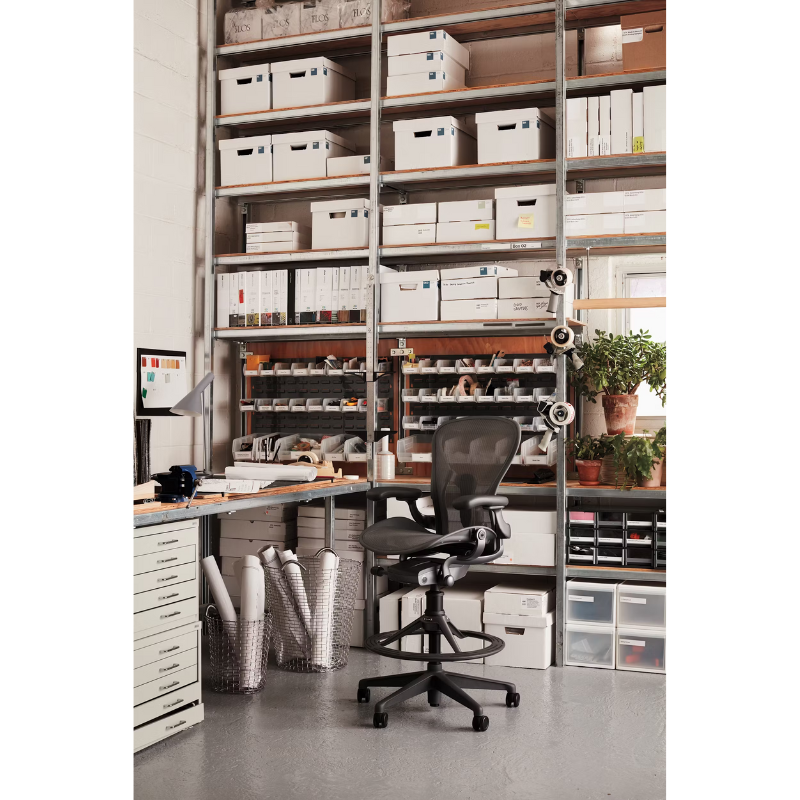 The Aeron Stool from Herman Miller in a business lifestyle photograph inside of a warehouse office.