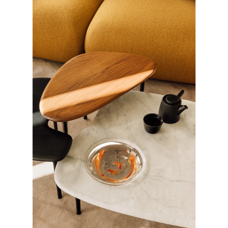 The low carrara marble table with bowl, mid black and high walnut Cyclade Tables from Herman Miller.