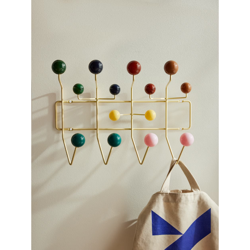 The Eames Hang-It-All rack from Herman Miller, designed by Herman Miller x Hay being used to hang a bag.