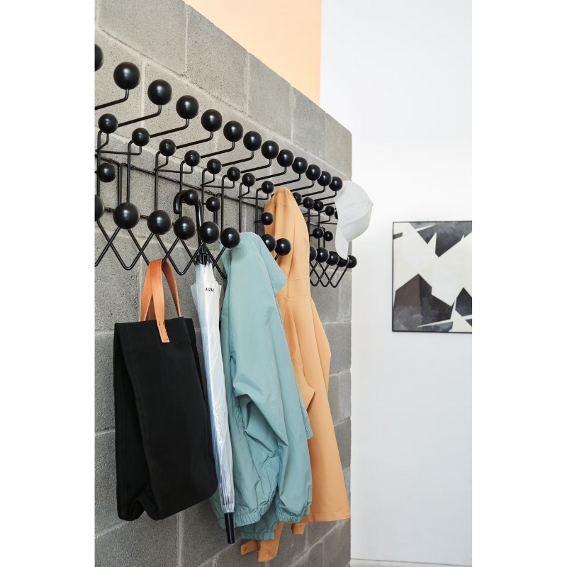 The Eames Hang-It-All from Herman Miller in a linear row, showing the multiple uses of the rack.