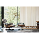 The Eames Lounge Chair and Ottoman from Herman Miller in an open space living room.