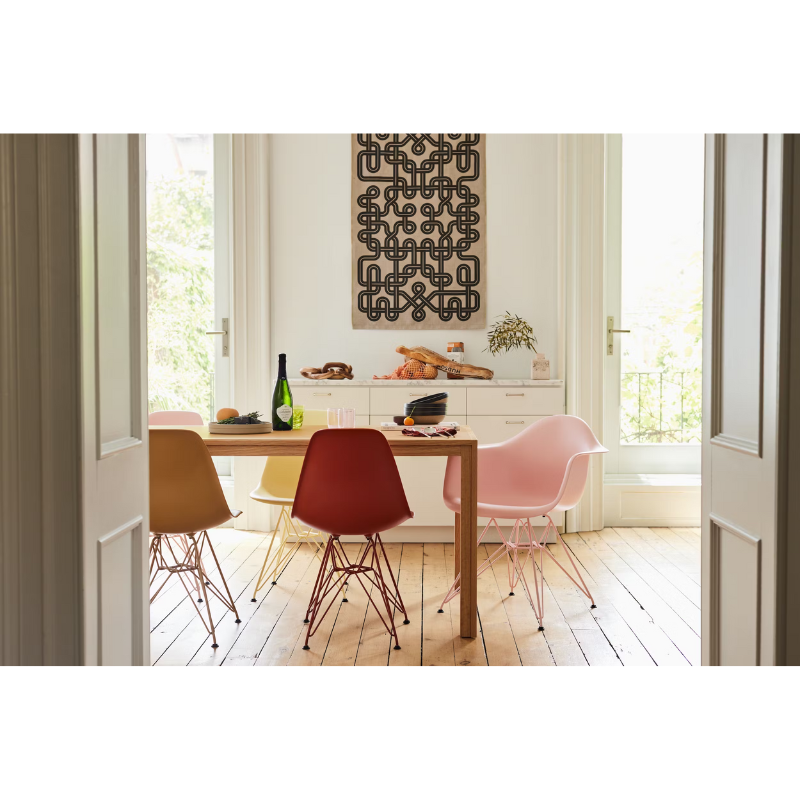 The Eames Molded Plastic Armchair by Herman Miller x HAY in a dining room.