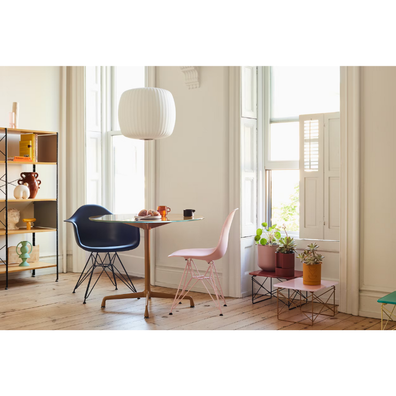 The Eames Molded Plastic Armchair by Herman Miller x HAY in a living room.