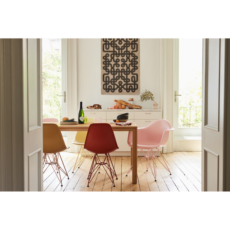 The Eames Molded Plastic Side Chair from Herman Miller designed by Herman Miller x HAY in a dining room.