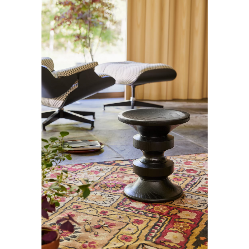 The Eames Turned Stool from Herman Miller in a family room.