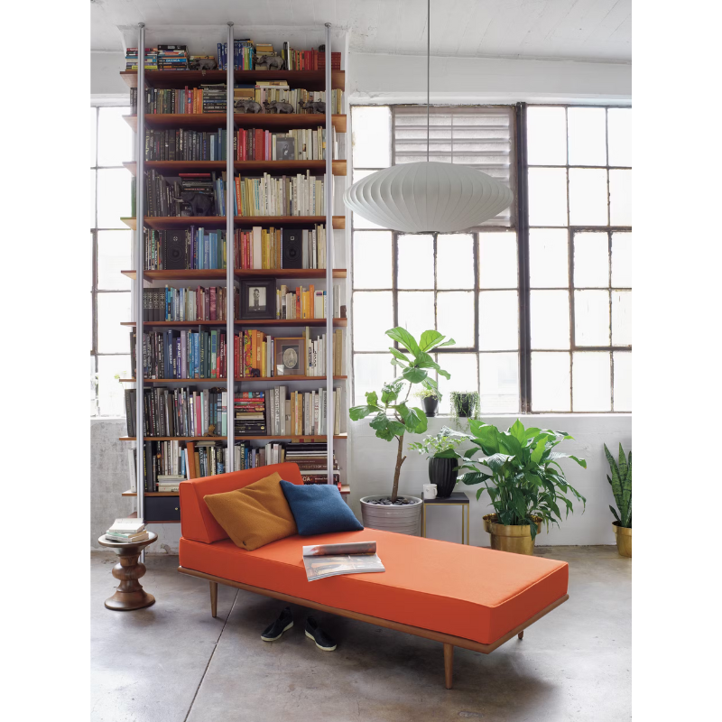 The Eames Turned Stool from Herman Miller in a home library.