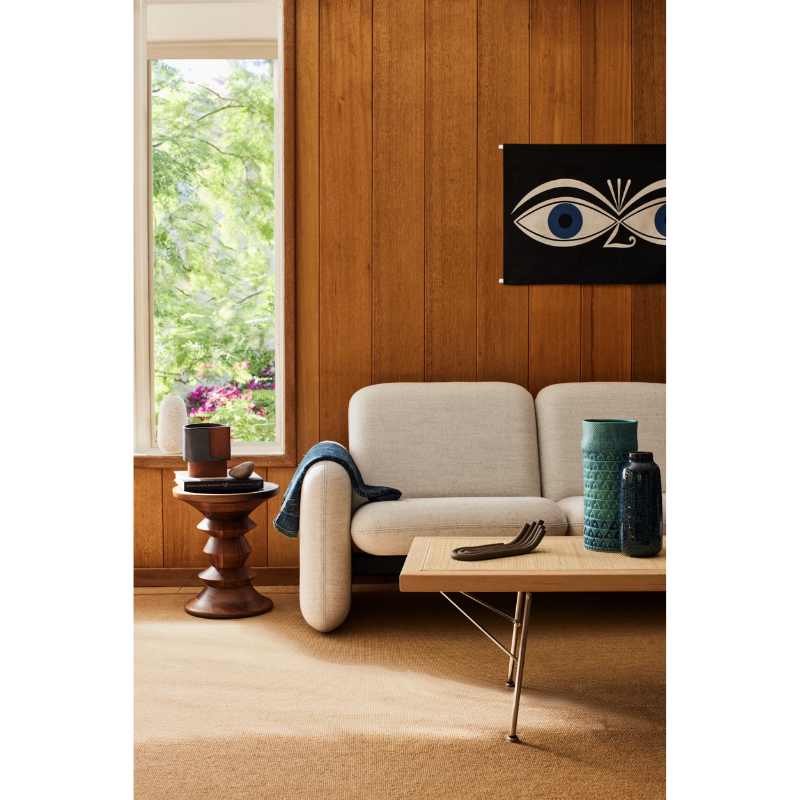 The Eames Turned Stool from Herman Miller in a living space.