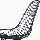 The Eames Wire Chair from Herman Miller, designed by Herman Miller x HAY in black blue with a close up on the seat.