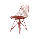 The Eames Wire Chair from Herman Miller, designed by Herman Miller x HAY in iron red with a color matching seat pad.