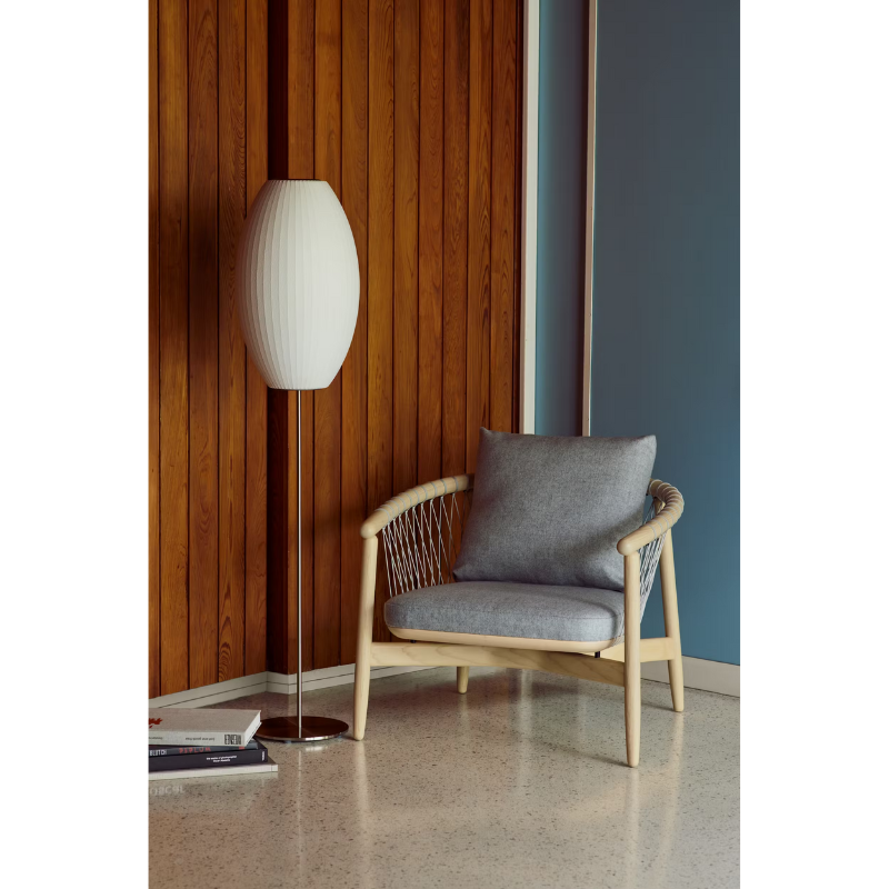The Nelson Cigar Lotus Floor Light from Herman Miller in a lifestyle photograph within a den.
