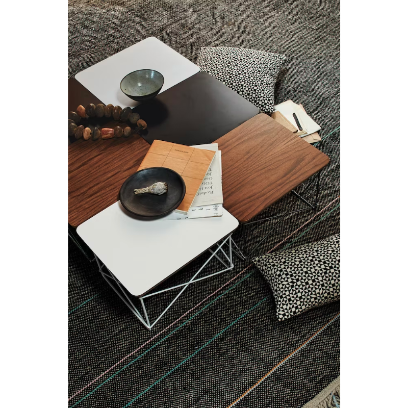 Just 10 inches high, the Eames Wire Base Low Table (1950) provides a handy surface for books or a bedside lamp. The beveled edges of the top of this Eames side table reveal seven layers of sturdy birch plywood. Portable and lightweight, these low wire base tables can be stacked for storage or grouped to form a larger surface. This is the authentic Wire Base Low Table produced by Herman Miller. Eames is a licensed trademark of Herman Miller.