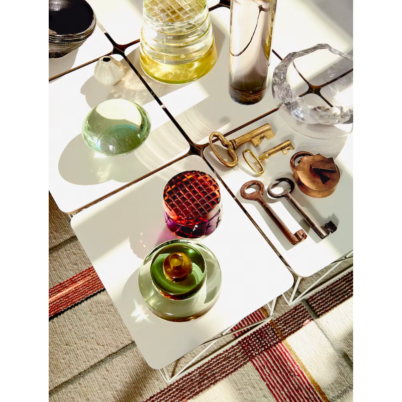 Just 10 inches high, the Eames Wire Base Low Table (1950) provides a handy surface for books or a bedside lamp. The beveled edges of the top of this Eames side table reveal seven layers of sturdy birch plywood. Portable and lightweight, these low wire base tables can be stacked for storage or grouped to form a larger surface. This is the authentic Wire Base Low Table produced by Herman Miller. Eames is a licensed trademark of Herman Miller.