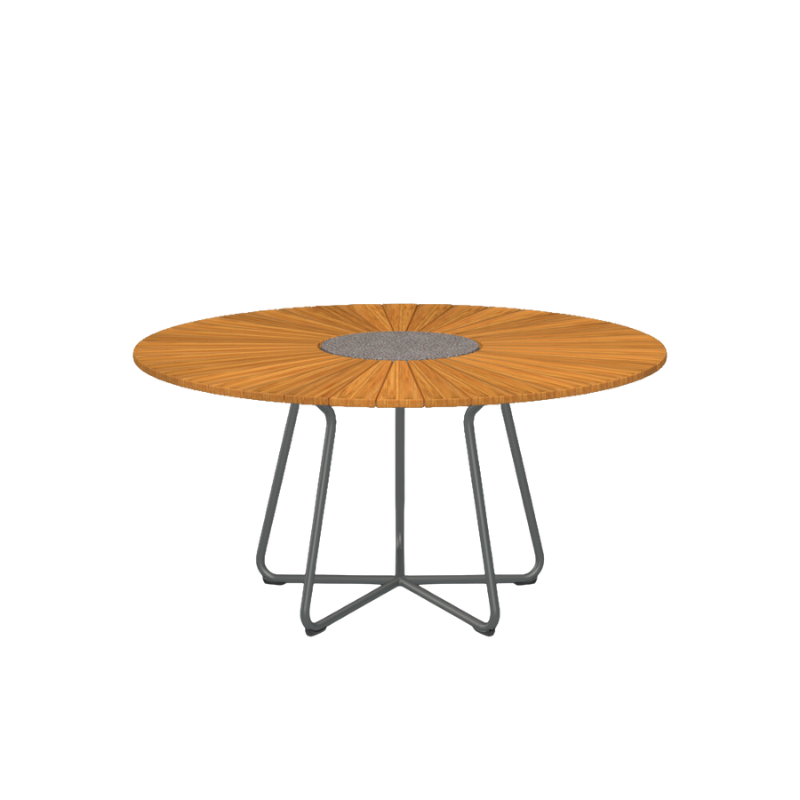 The CIRCLE outdoor dining table by Houe features a bamboo table top with a granite stone center and grey aluminum legs. This outdoor dining table is elegant and thoughtfully designed and will make a great addition to your garden. Its unique leg construction allows for free seating, as the legs are drawn in under the table providing ample legroom for a comfortable dining experience. 