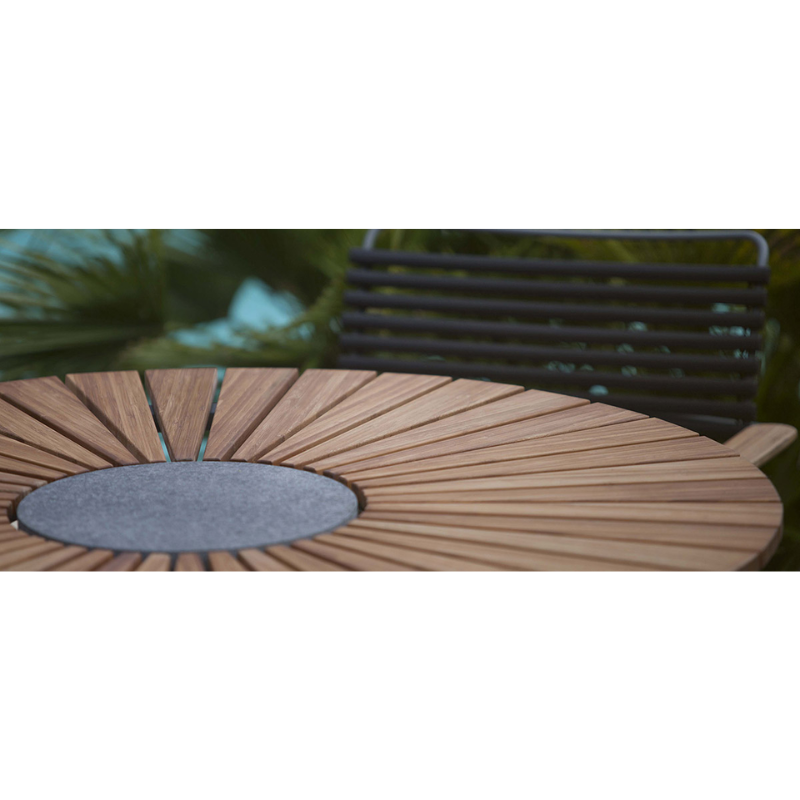 The CIRCLE outdoor dining table by Houe features a bamboo table top with a granite stone center and grey aluminum legs. This outdoor dining table is elegant and thoughtfully designed and will make a great addition to your garden. Its unique leg construction allows for free seating, as the legs are drawn in under the table providing ample legroom for a comfortable dining experience. 