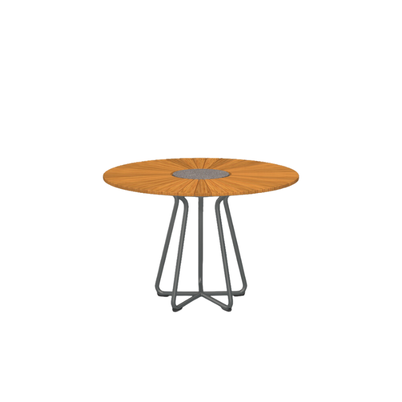 The CIRCLE outdoor dining table by Houe features a bamboo table top with a granite stone center and grey aluminum legs. This outdoor dining table is elegant and thoughtfully designed and will make a great addition to your garden. Its unique leg construction allows for free seating, as the legs are drawn in under the table providing ample legroom for a comfortable dining experience. 