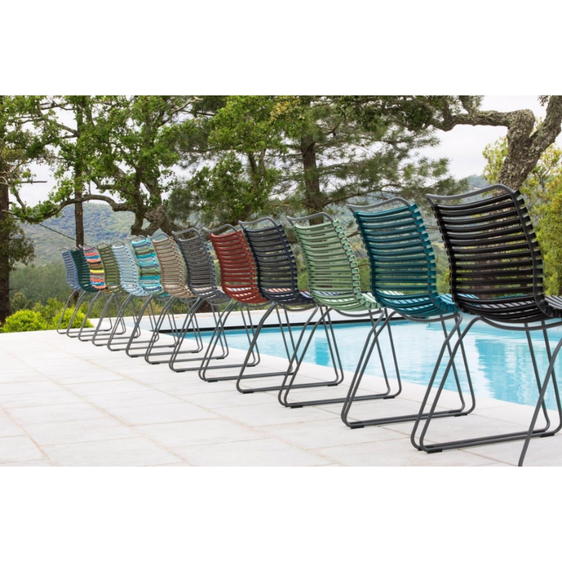 CLICK outdoor chair is simple, honest, and ergonomically well thought out. It is beautiful in its repetition around the table and because the slats (lamellas) can be replaced, you can mix and change the colors as often as you like. These outdoor dining chairs are stackable and easy to store. 