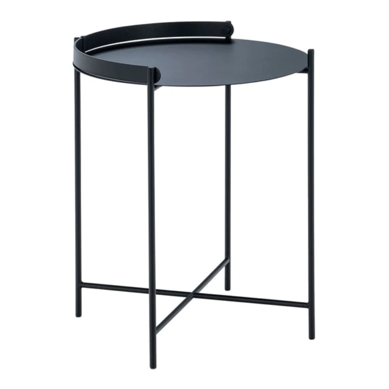 The EDGE tray table is a versatile piece of furniture that can be used both indoors and outdoors. It is made of powder-coated metal and comes in three different sizes. The half-ring shaped handle makes it easy to move the table between the living room and the garden, and when laid down it functions as a table edge making sure everything stays in place.