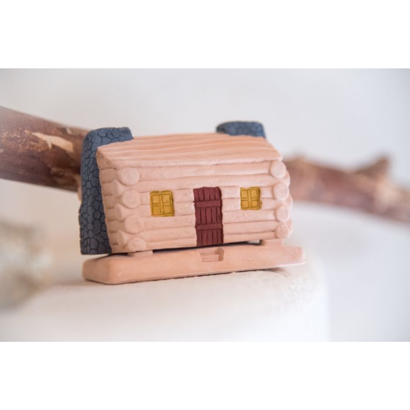 The Log Cabin Incense Burner from Inscents in a living room.