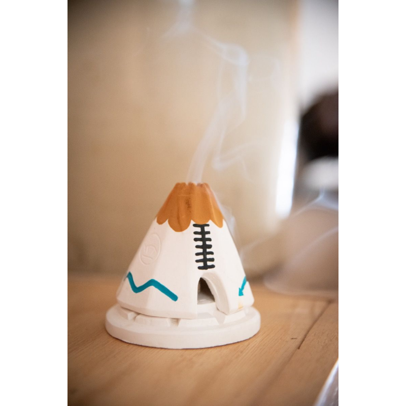 The White Teepee Incense Burner from Inscents being used in a living room lifestyle shot.