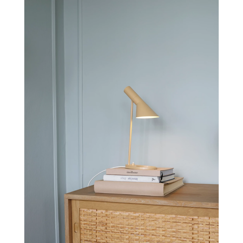 The AJ Mini Table Lamp from Louis Poulsen in a bedroom.