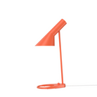 The AJ Mini Table Lamp from Louis Poulsen in electric orange.