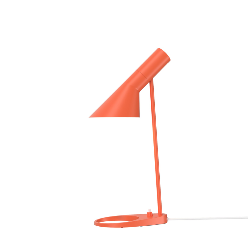 The AJ Mini Table Lamp from Louis Poulsen in electric orange.