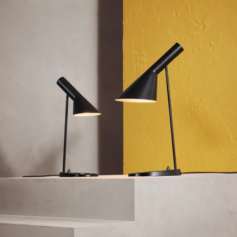The AJ Mini Table Lamp from Louis Poulsen in a lighting studio.