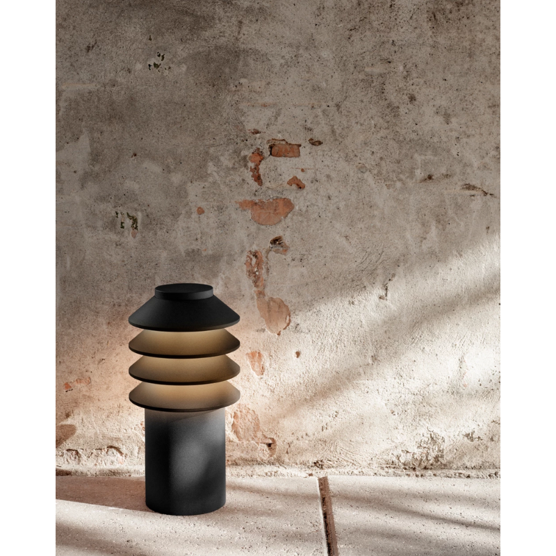 Its downscaled design is based on the same concept as the original Bysted. Four rings redirect the light downward while glowing at night and giving the product individuality and character. 