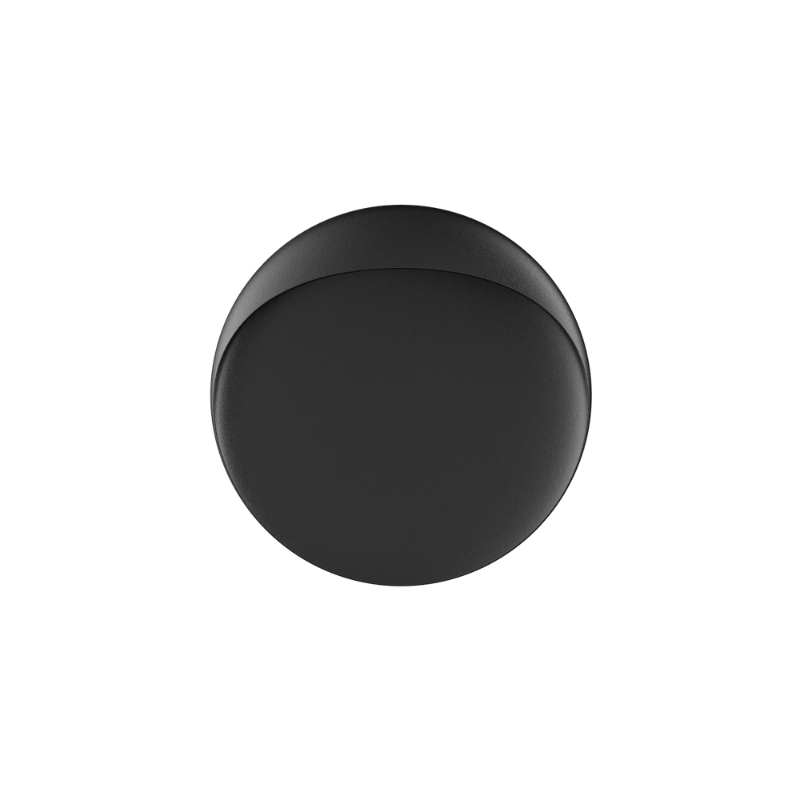 The Flindt Wall is distinguished by a light egress from an opening in the top that emits light down the front of the fixture, creating a subtle, glowing ring of reflected light on the transition between the concave and convex shapes. The oval shape is lifted off the mounting surface, giving the fixture a floating appearance.