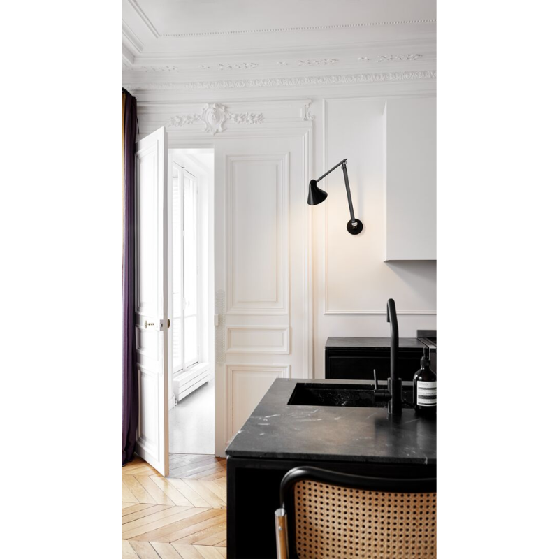 The NJP series was designed by Oki Sato, with the intention of producing a new interpretation of the classic anglepoise lamp. The NJP Wall lamp’s flexible head and arms provide exceptional adjustability, which is often lacking in standard wall lights. One refined yet practical detail is the fixture's chimney-shaped head, which reflects some of the light through the rear.