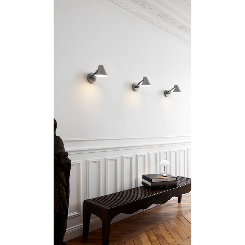 The NJP series was designed by Oki Sato, with the intention of producing a new interpretation of the classic anglepoise lamp. The NJP Wall lamp’s flexible head and arms provide exceptional adjustability, which is often lacking in standard wall lights. One refined yet practical detail is the fixture's chimney-shaped head, which reflects some of the light through the rear.