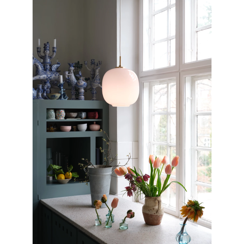 The VL45 Radiohus Pale Rose Pendant from Louis Poulsen in a kitchen and dining setting.