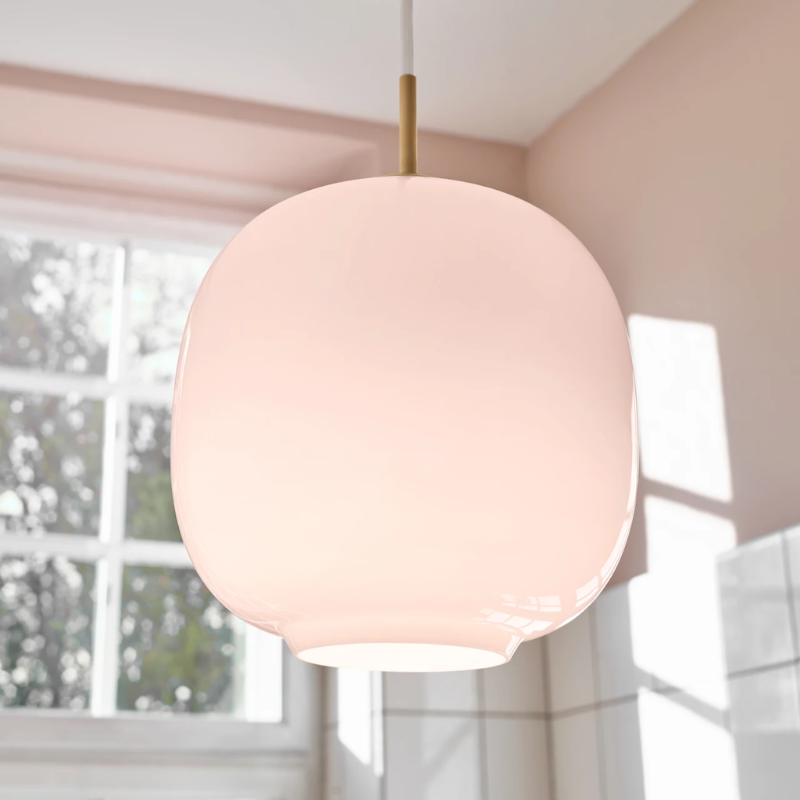The VL45 Radiohus Pale Rose Pendant from Louis Poulsen in a living room.