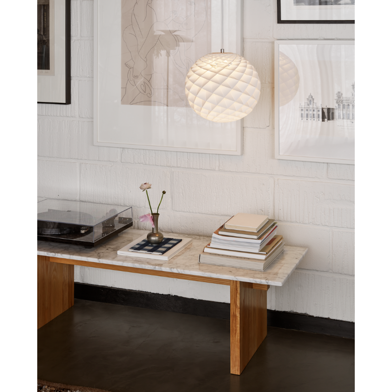The Patera pendant is a glowing sphere built up of small diamond-shaped cells. Each cell is carefully designed to capture light and to shield the light source from the viewing angles above 45 degrees. Each cell glows. Below 45 degrees, the fields are open to direct light downwards. A small amount of light is also sent upwards to illuminate the ceiling. Designed by Danish designer Øivind Slaatto who took inspiration from the Fibonacci spiral.