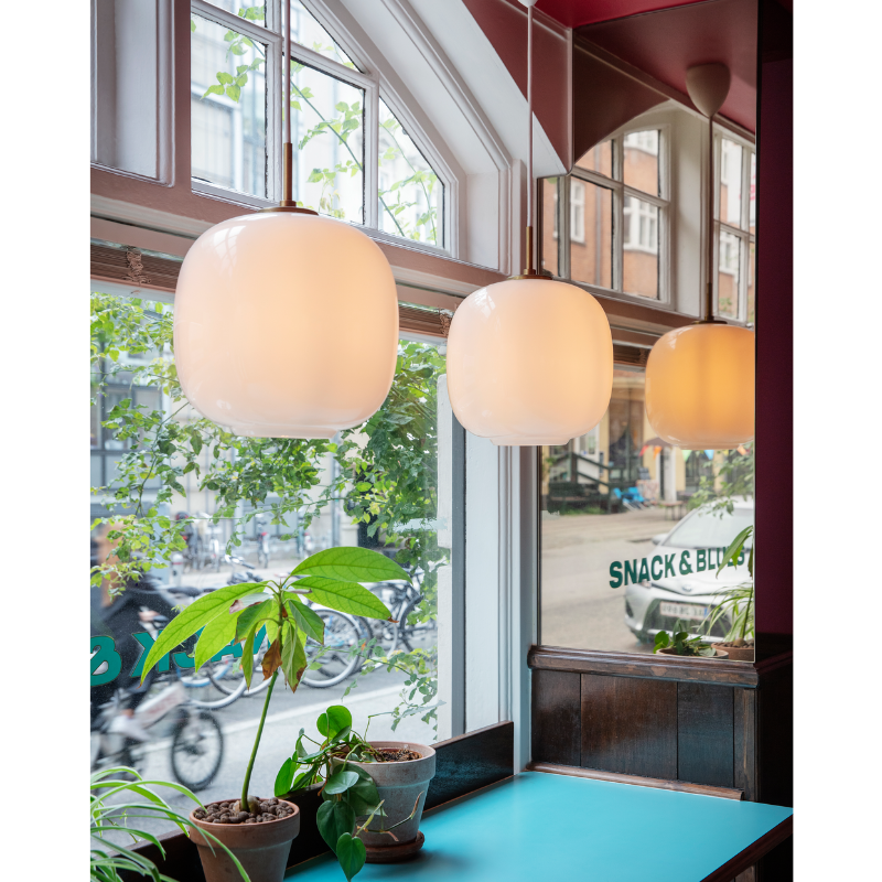 Originally designed in the 1940s by Vilhelm Lauritzen for a project in Copenhagen, the Louis Poulsen VL45 Radiohus Pendant is everything we love about modern design. The lantern shape is smooth and crisply rendered from three layers of hand-blown glass, casting a glowing light from its center that is both functional and beautiful to witness. The glass is topped with a Brushed Brass tube, adding a nice metallic accent to the warmth of the opal glass.