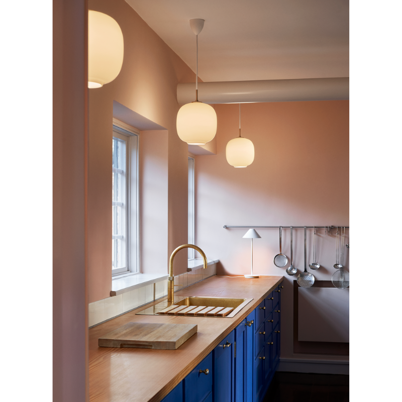Originally designed in the 1940s by Vilhelm Lauritzen for a project in Copenhagen, the Louis Poulsen VL45 Radiohus Pendant is everything we love about modern design. The lantern shape is smooth and crisply rendered from three layers of hand-blown glass, casting a glowing light from its center that is both functional and beautiful to witness. The glass is topped with a Brushed Brass tube, adding a nice metallic accent to the warmth of the opal glass.