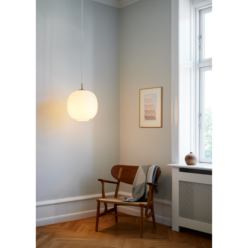 Originally designed in the 1940s by Vilhelm Lauritzen for a project in Copenhagen, the Louis Poulsen VL45 Radiohus Pendant is everything we love about modern design. The lantern shape is smooth and crisply rendered from three layers of hand-blown glass, casting a glowing light from its center that is both functional and beautiful to witness. The glass is topped with a Brushed Brass tube, adding a nice metallic accent to the warmth of the opal glass.